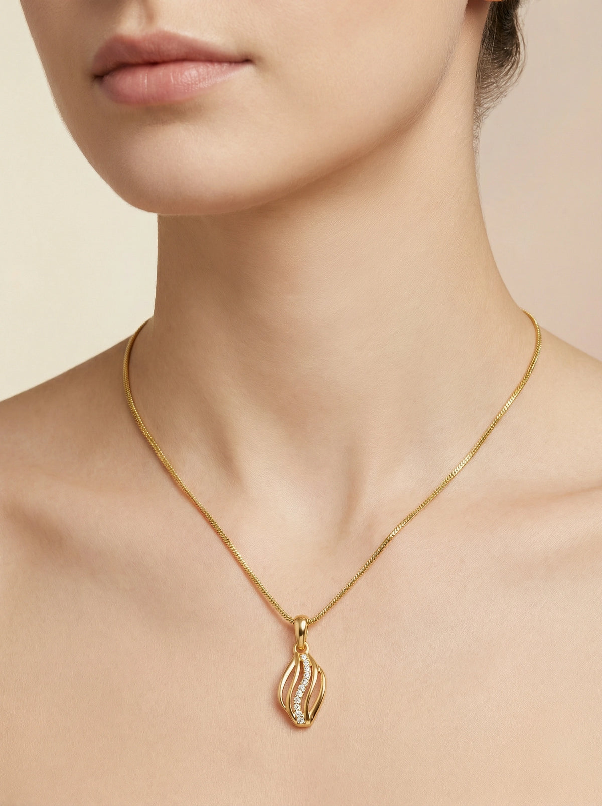 18k gold plated necklace with a pendant on a neutral background