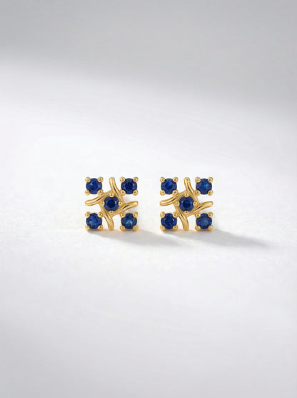 `8k Gold plated earrings with blue gemstones on a light gray background
