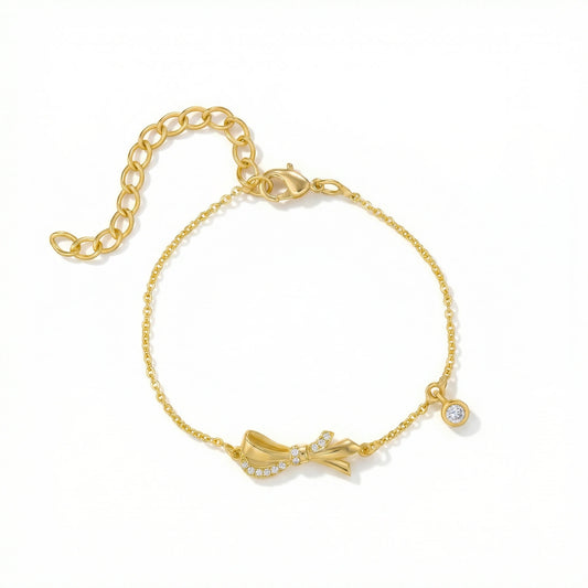 18k Gold plated  bracelet with a bow design on a white background