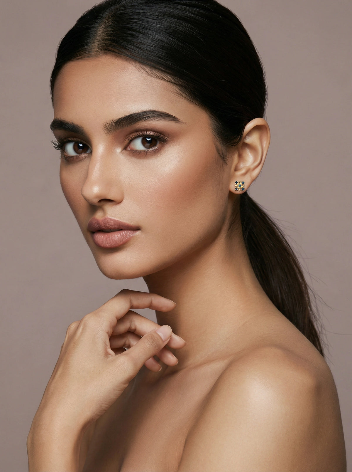 Woman with a smooth neck and shoulder against a neutral background