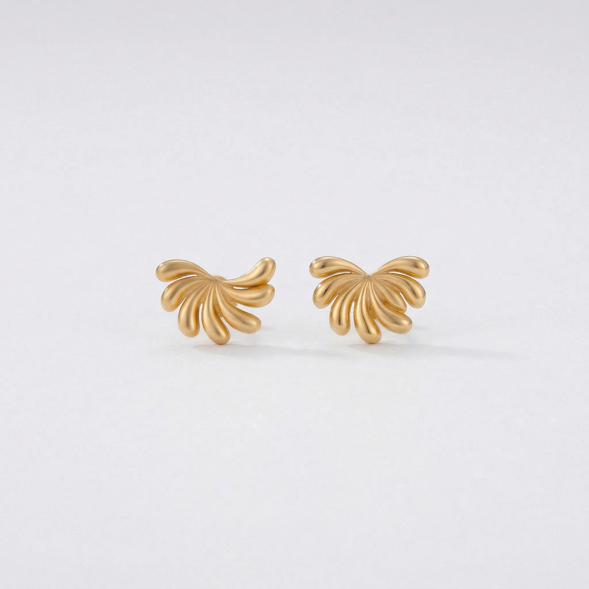 18k Gold plated butterfly-shaped earrings on a light gray background