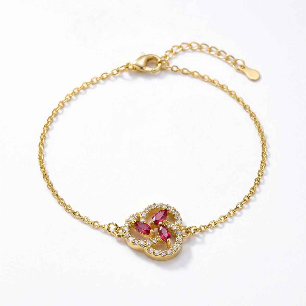 18k gold plated bracelet with a heart-shaped clasp featuring red gemstones on a white background