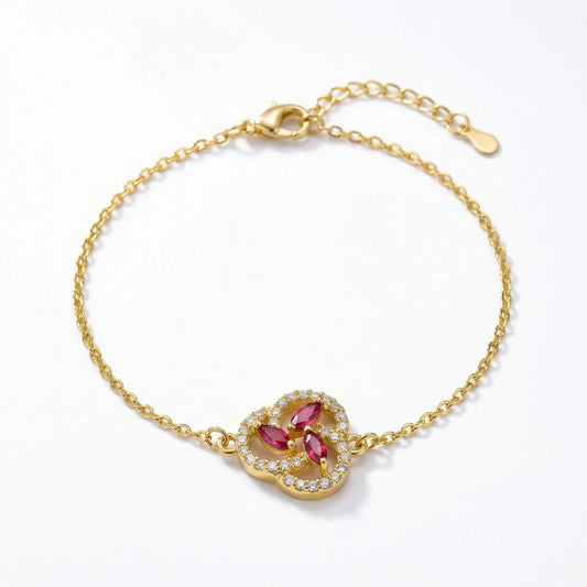 18k Gold plated bracelet with a heart-shaped clasp featuring red gemstones on a white background