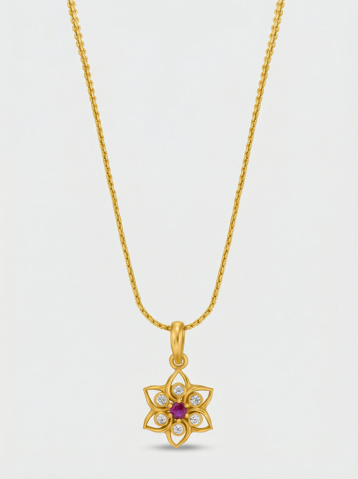 18k Gold plated necklace with a floral pendant on a light gray background