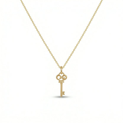 18k Gold  plated  key-shaped pendant on a chain against a white background