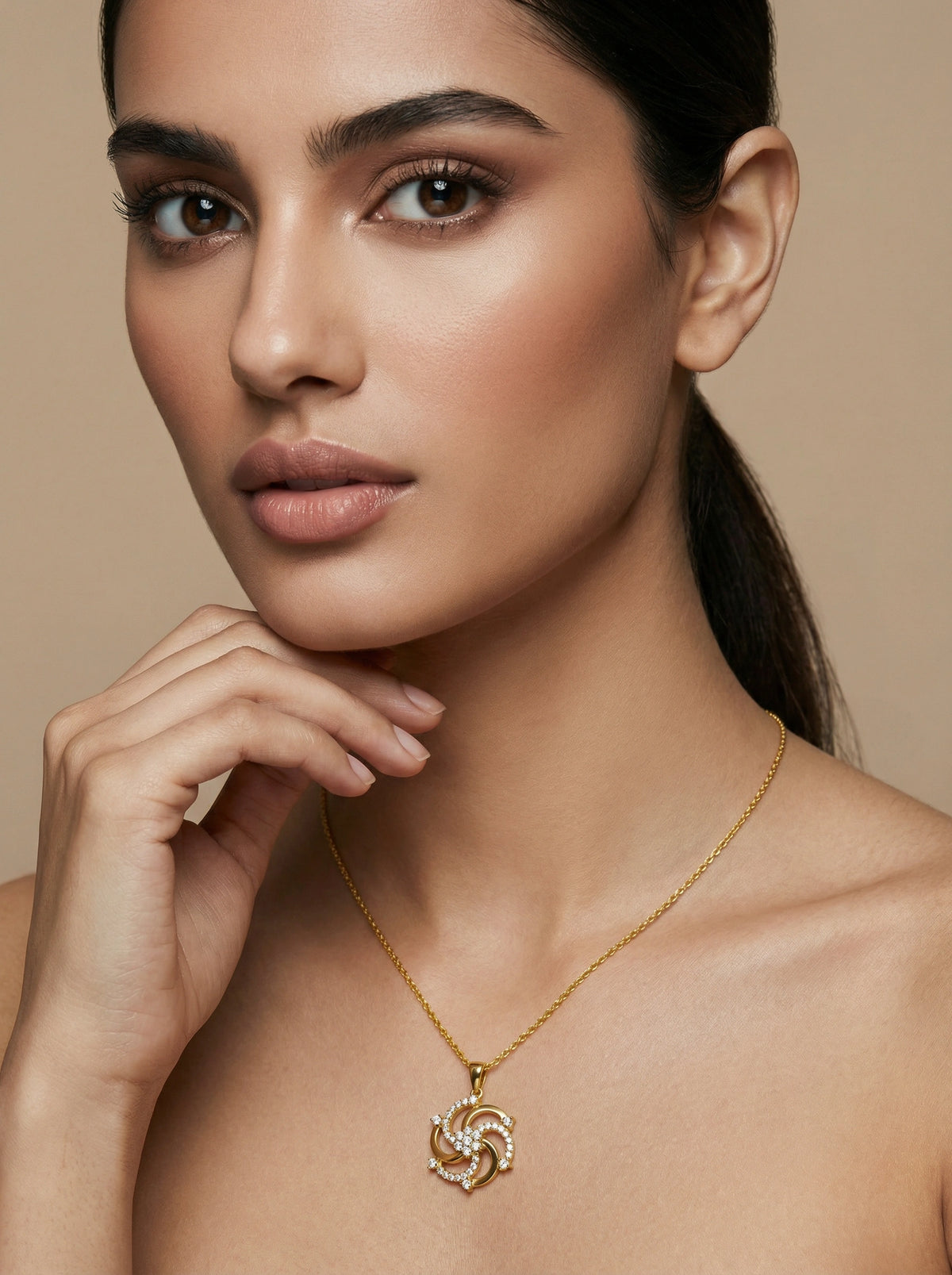 woman wearing a 18k gold plated necklace with a heart pendant against a beige background