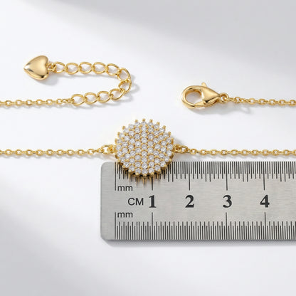 18k Gold plated bracelet with a decorative clasp on a ruler for size reference