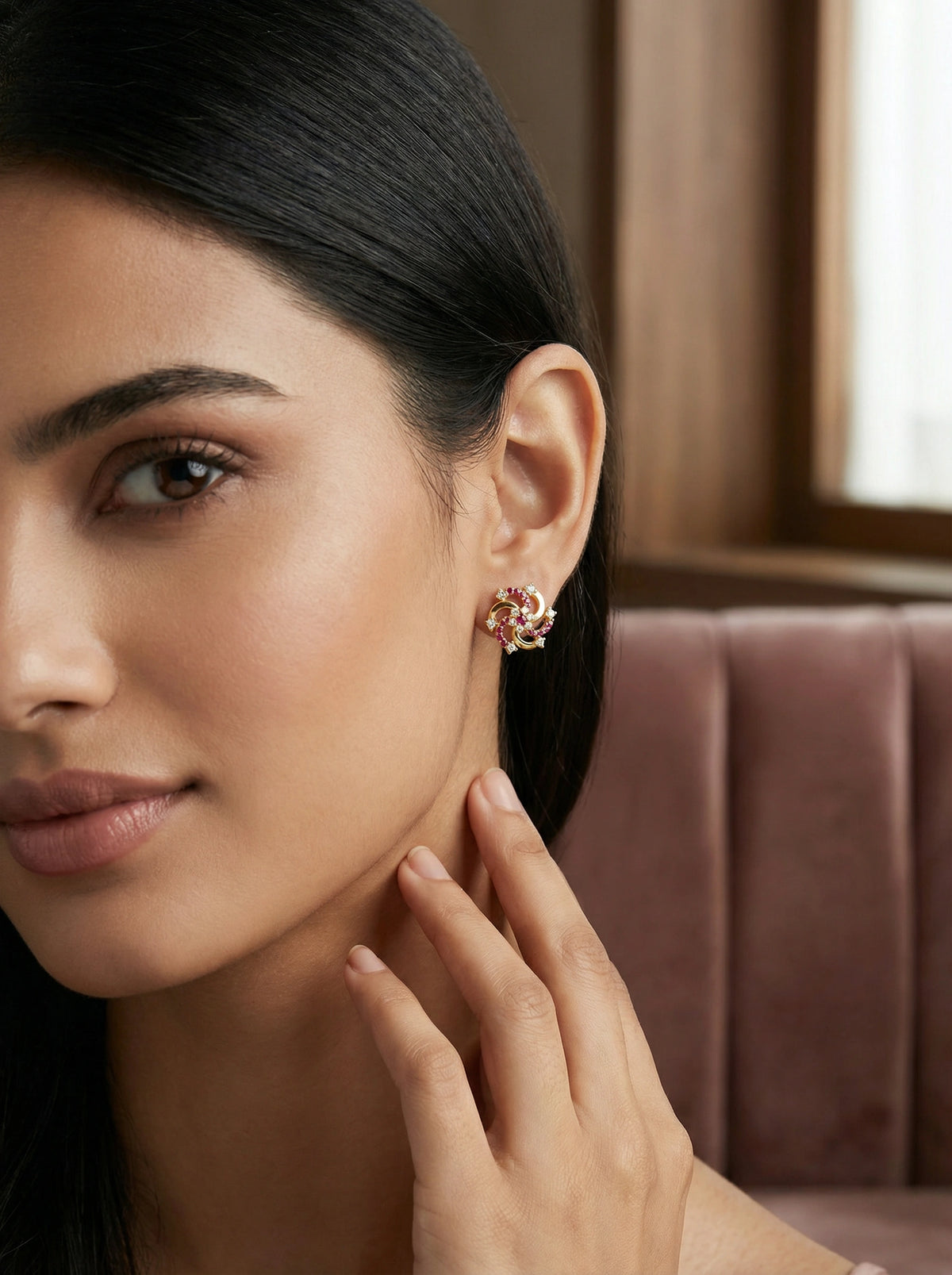 woman wearing a floral 18k gold plated earring with a blurred background