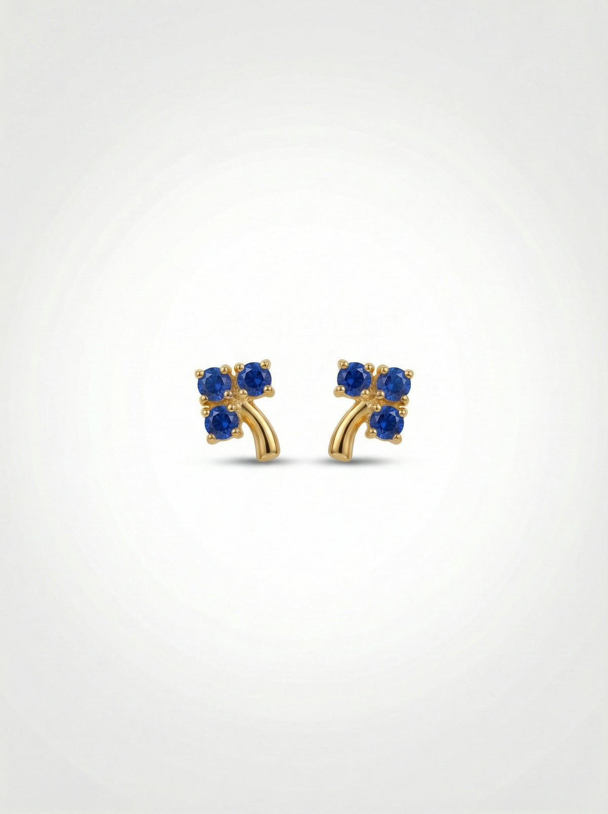 18k Gold plated earrings with blue gemstones on a white background