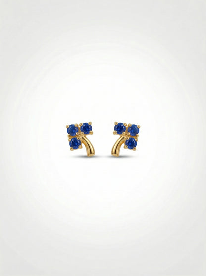 18k Gold plated earrings with blue gemstones on a white background