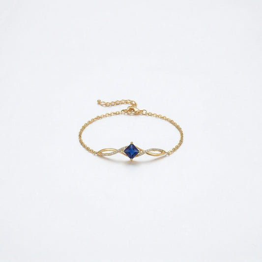 18k Gold plated  bracelet with a blue gemstone on a white background