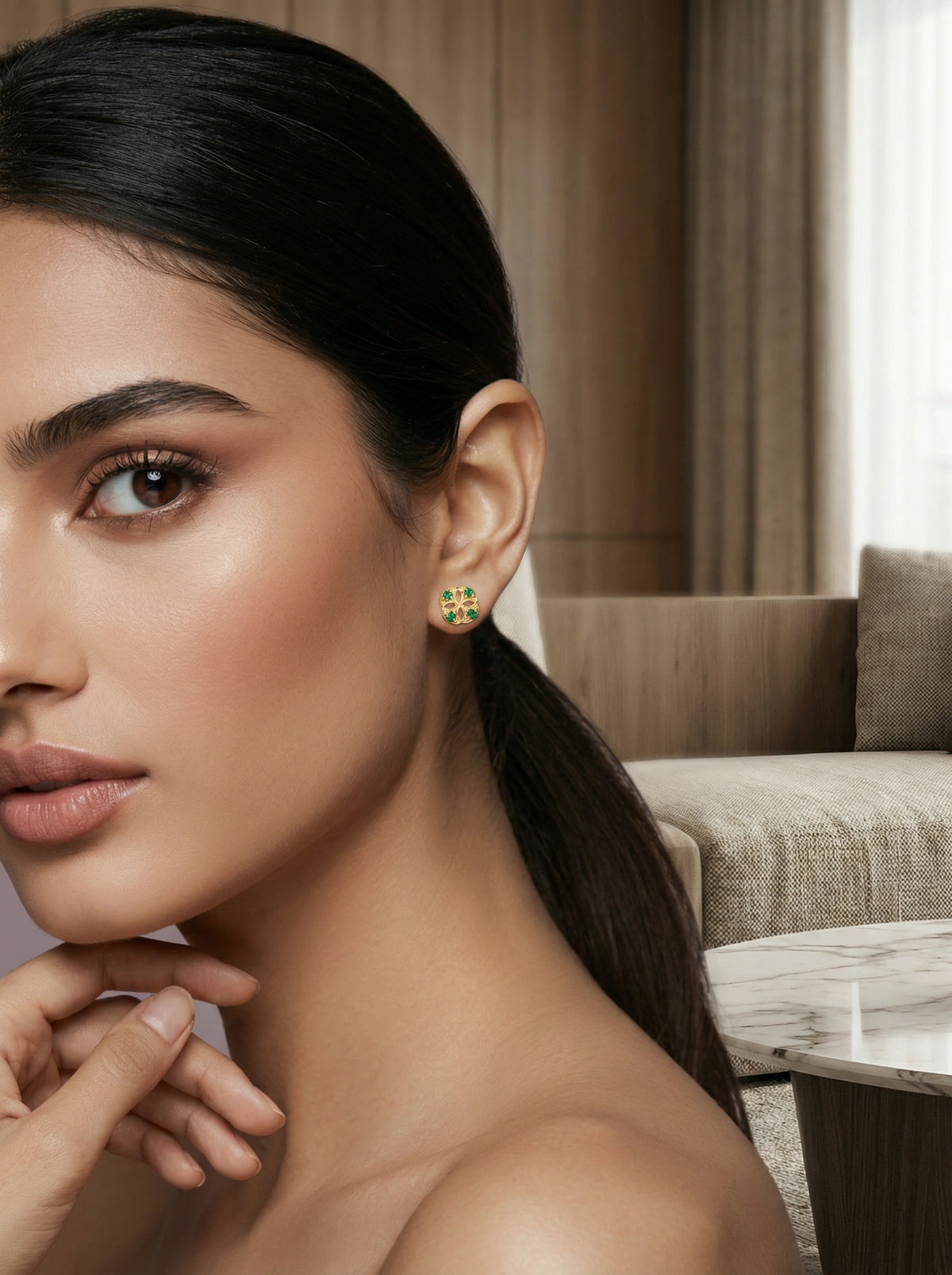 woman wearing 18k gold plated green earrings in a living room setting