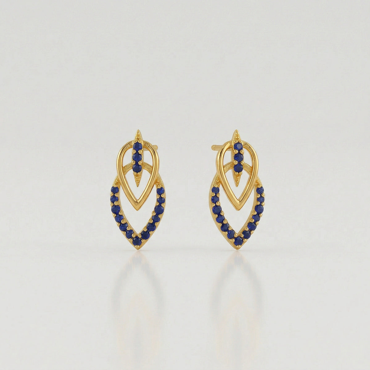 18k Gold plated  earrings with blue stones on a light gray background