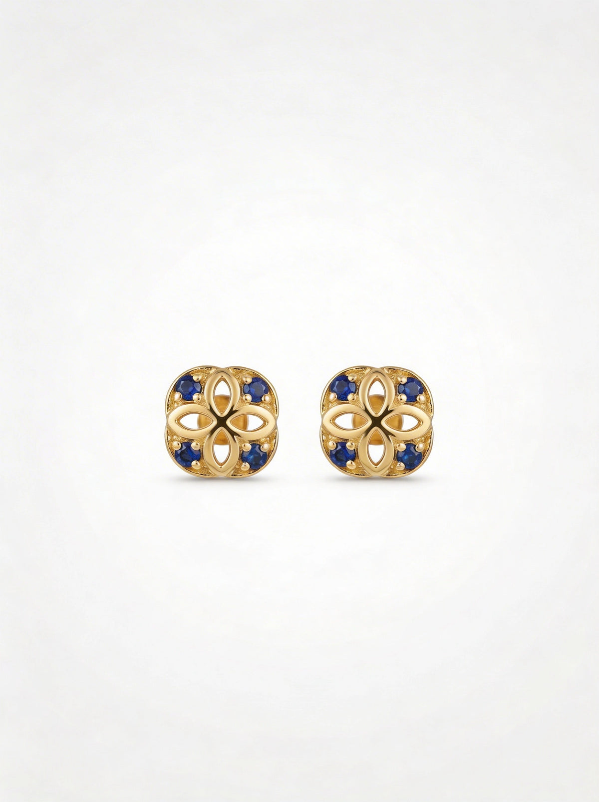 18k Gold plated earrings with blue stones on a white background