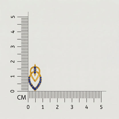 Jewelry with blue stones and 18k gold plated  accents next to a ruler on a gray background