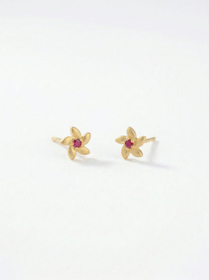 18k Gold plated flower-shaped earrings with red gemstones on a white background