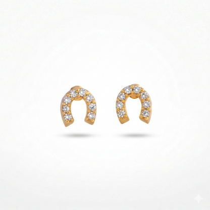 Gold horseshoe-shaped earrings with embedded stones on a white background