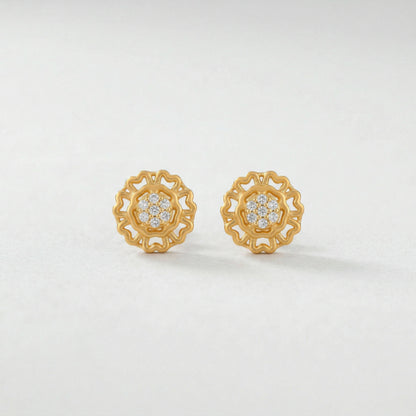 Pair of 18k gold plated earrings with diamond accents on a light gray background