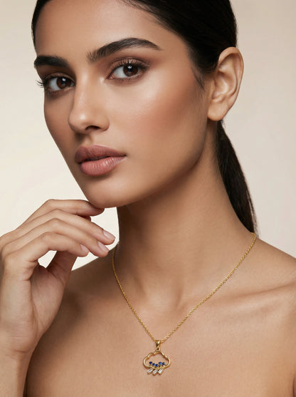 Woman wearing a18k gold plated necklace with a pendant against a neutral background