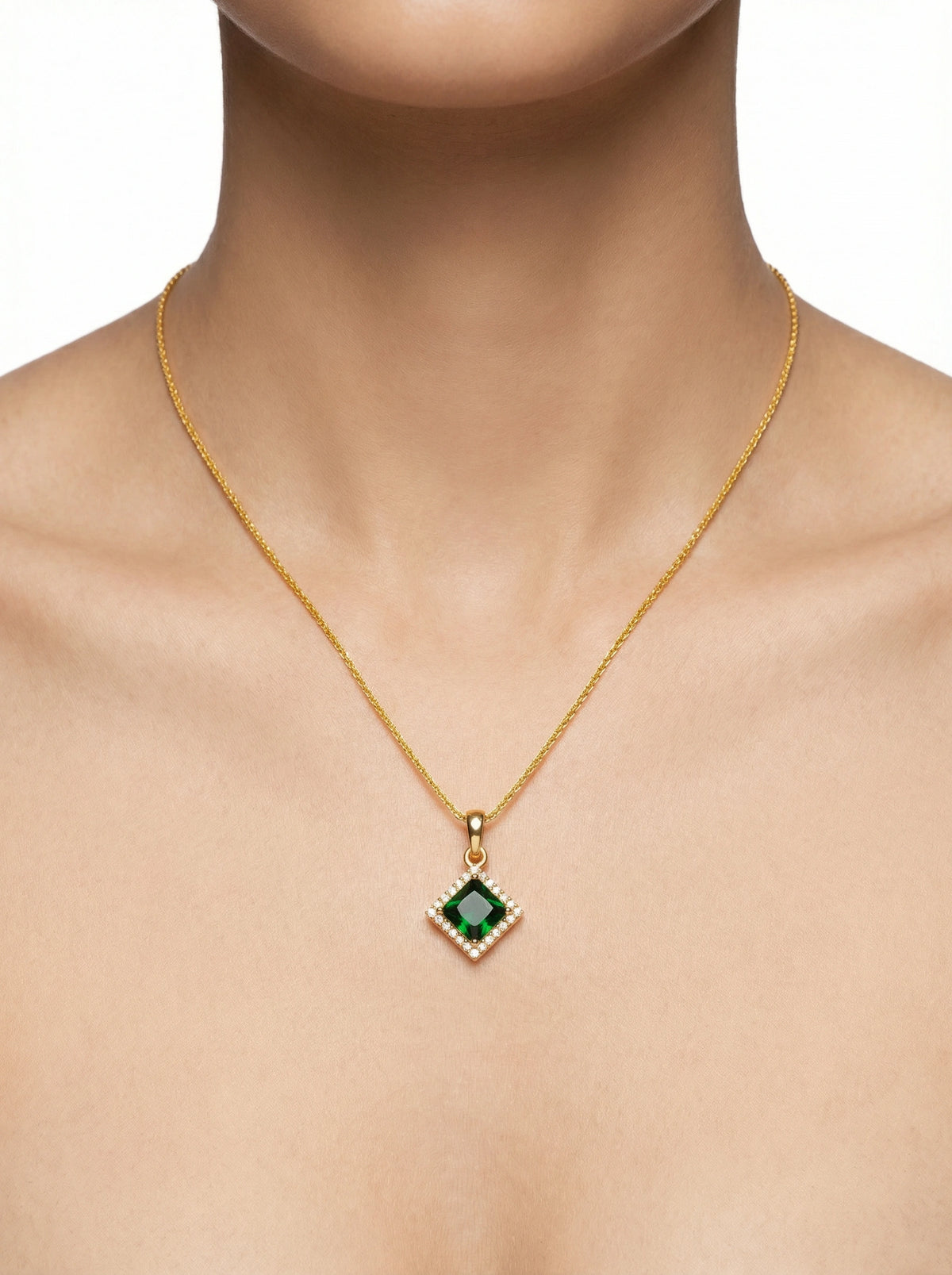 18k gold plated necklace with a green gemstone pendant on a mannequin