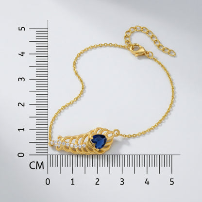 18k Gold plated bracelet with a blue gemstone next to a ruler for measurement on a white background