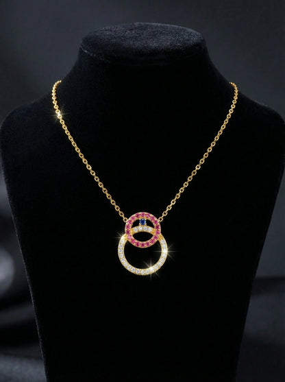 18k gold plated Necklace with interlocking rings on a black stand against a dark background
