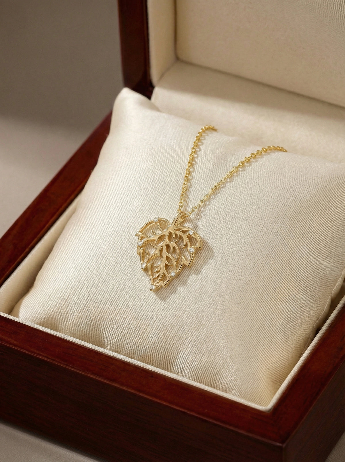 18k gold plated necklace with a heart-shaped pendant in an open jewelry box.