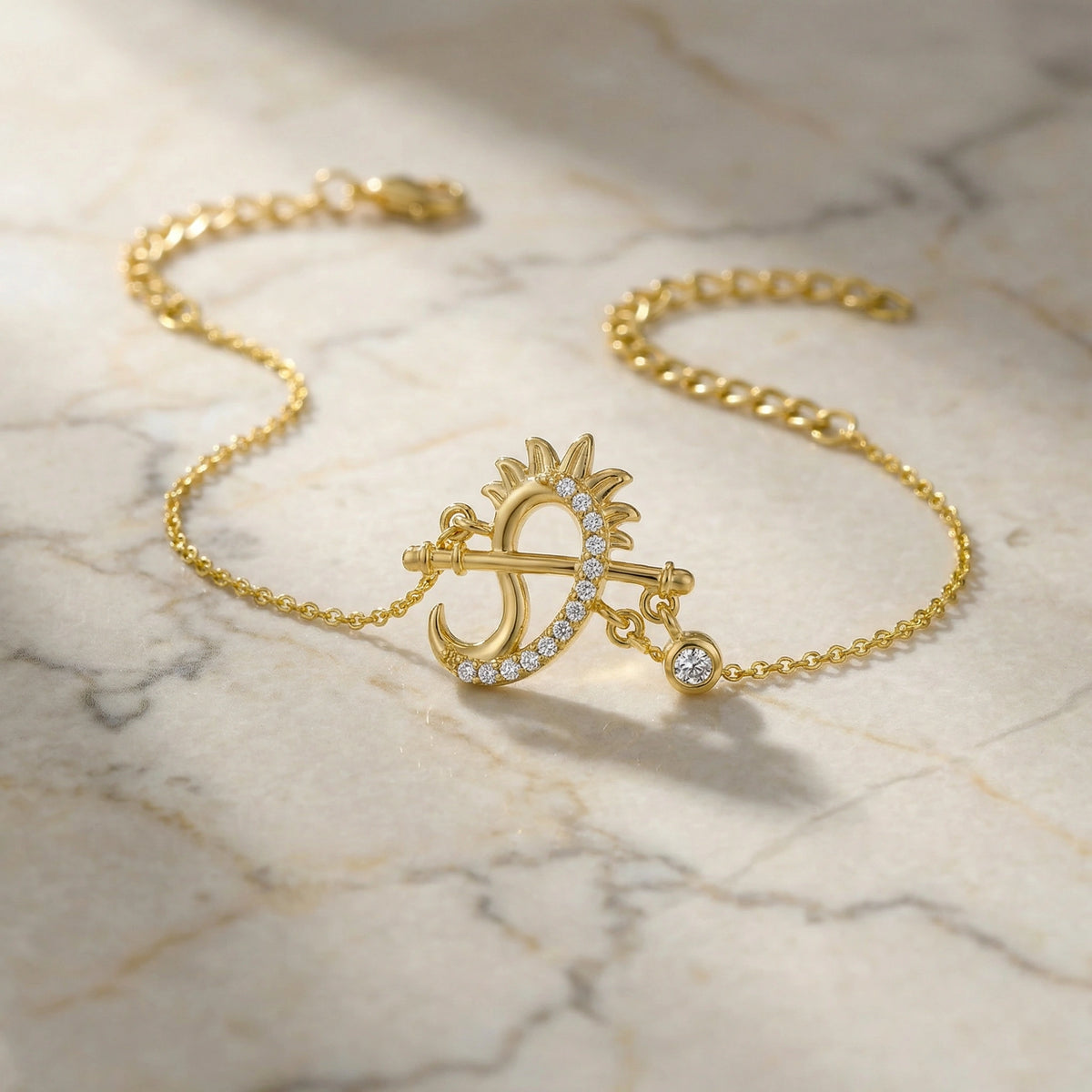18k gold plated bracelet with a sun and moon design on a marble surface