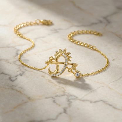 18k Gold plated bracelet with a sun and moon design on a marble surface