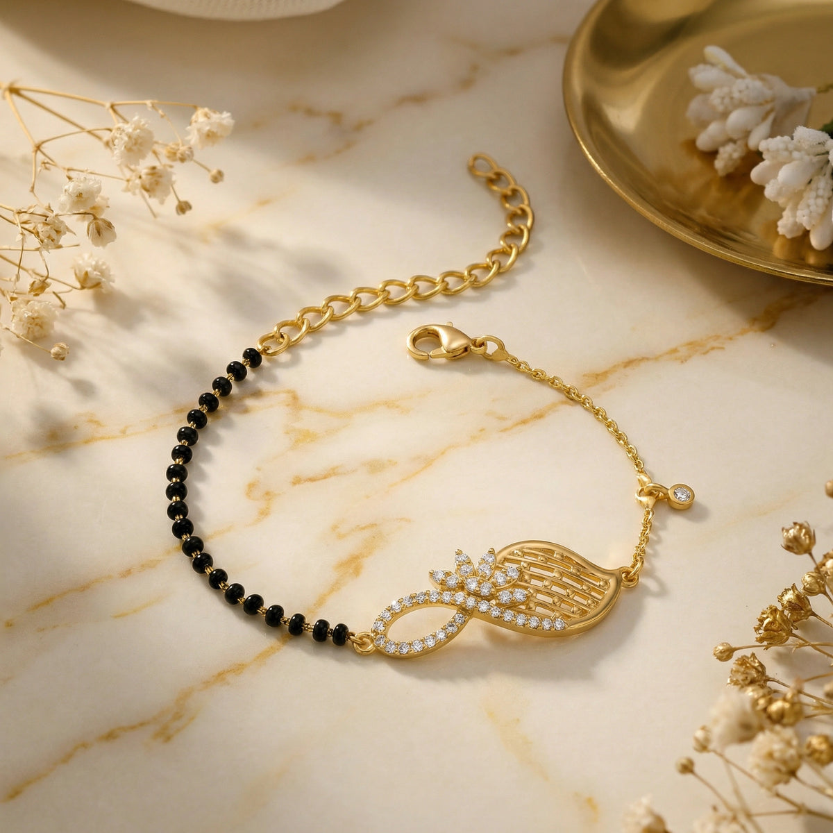 18k gold plated bracelet with black beads on a marble surface