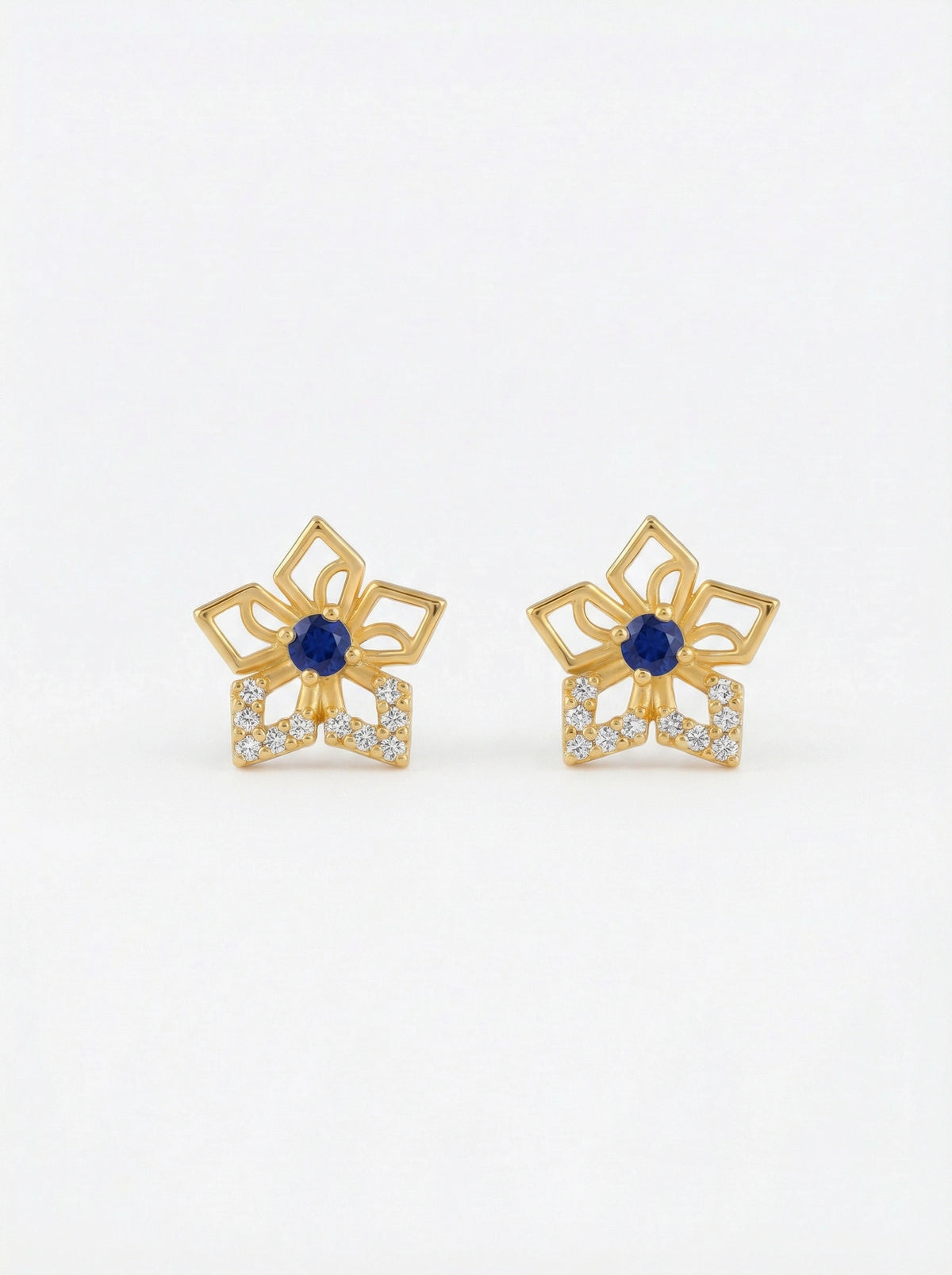 pair of 18k gold plated earrings with blue gemstones on a white background