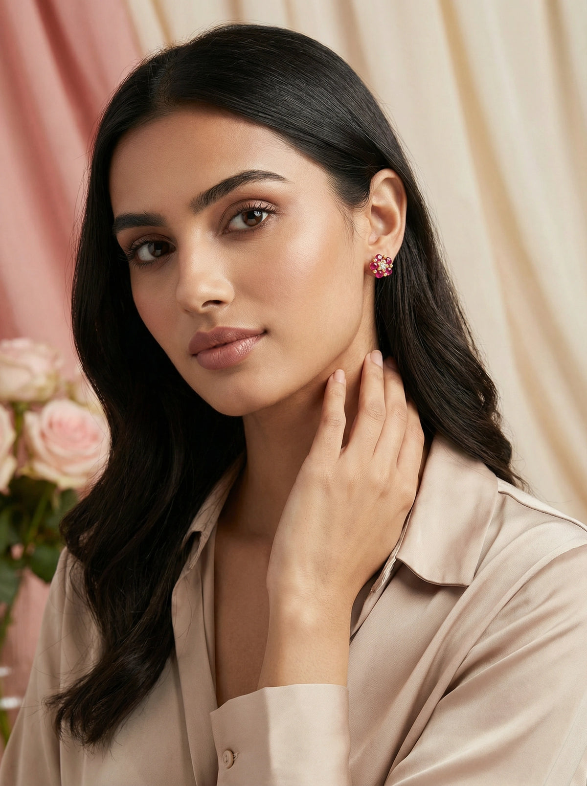 woman wearing 18k gold plated  earrings with a soft, blurred background