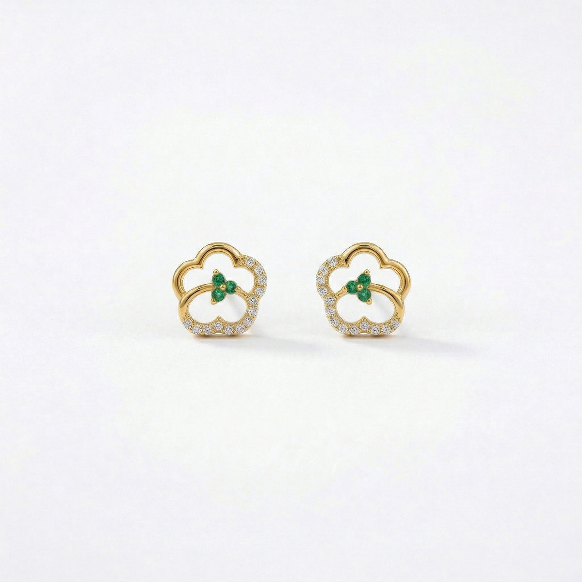 18k Gold plated earrings with green gemstones on a white background