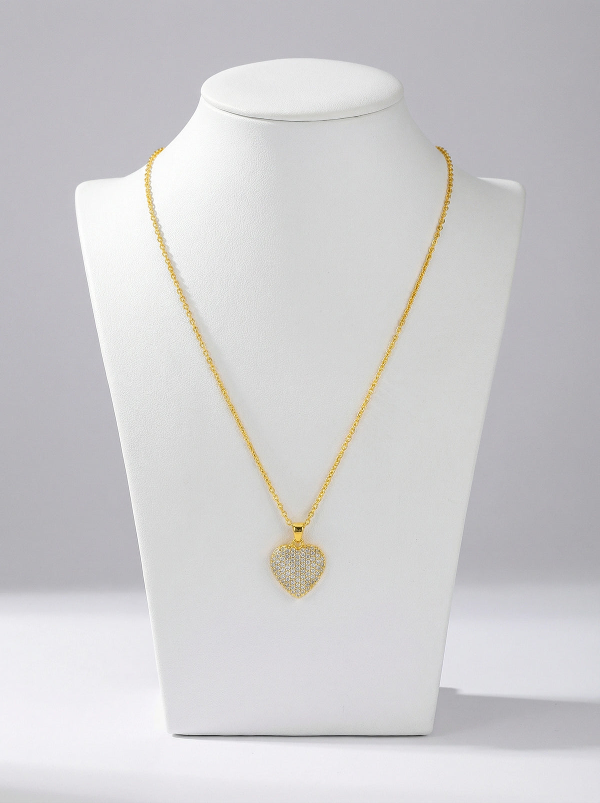 18k Gold plated necklace with a heart-shaped pendant on a white mannequin bust against a gray background