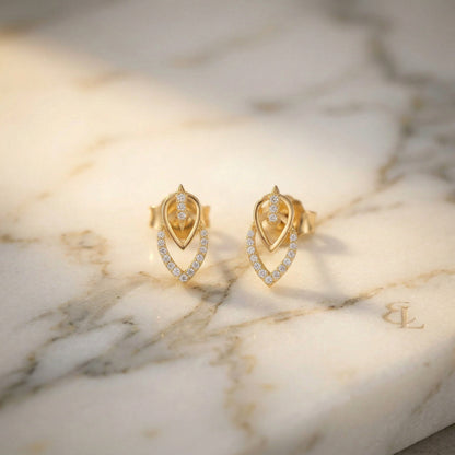 18k Gold plated earrings with diamond accents on a marble surface