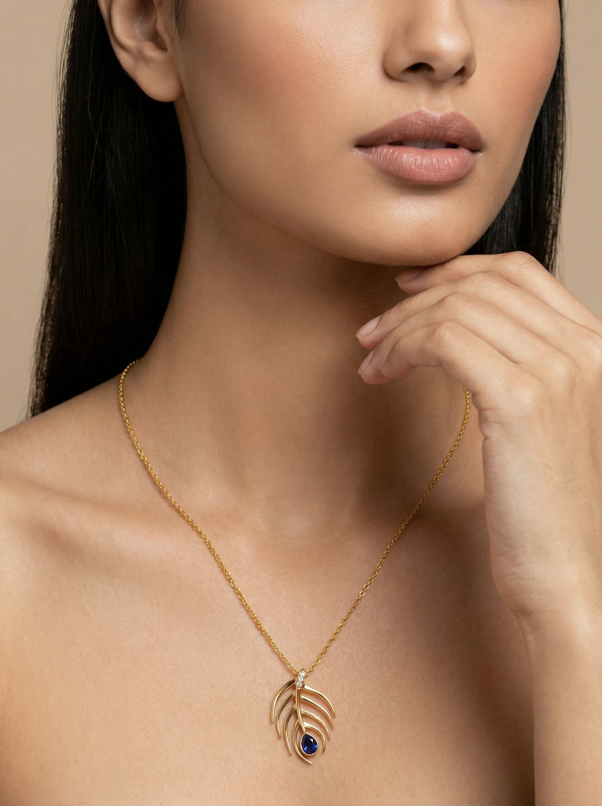 18k gold plated necklace with a blue gemstone pendant on a model against a neutral background