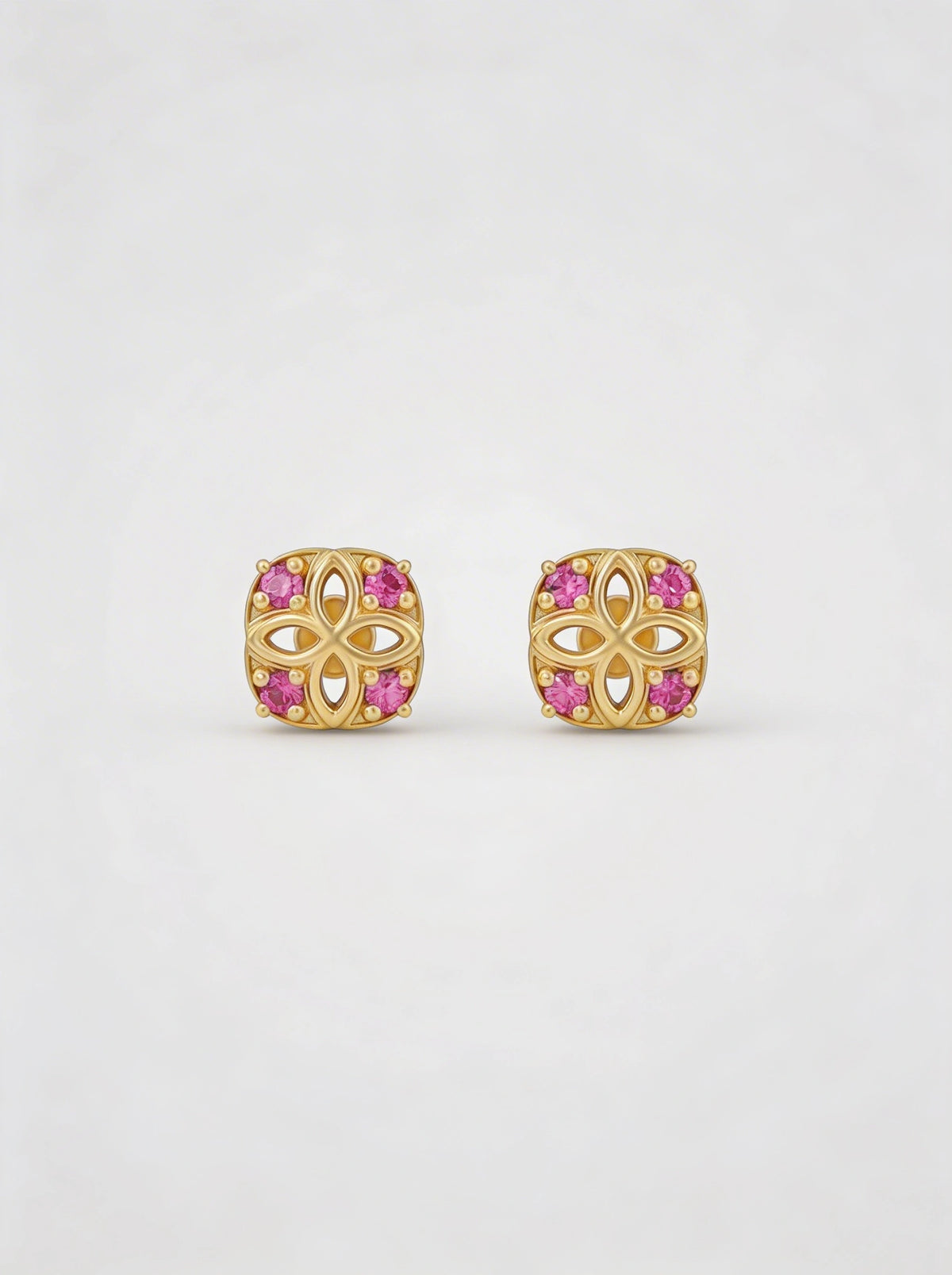 18k Gold plated earrings with pink gemstones on a white background