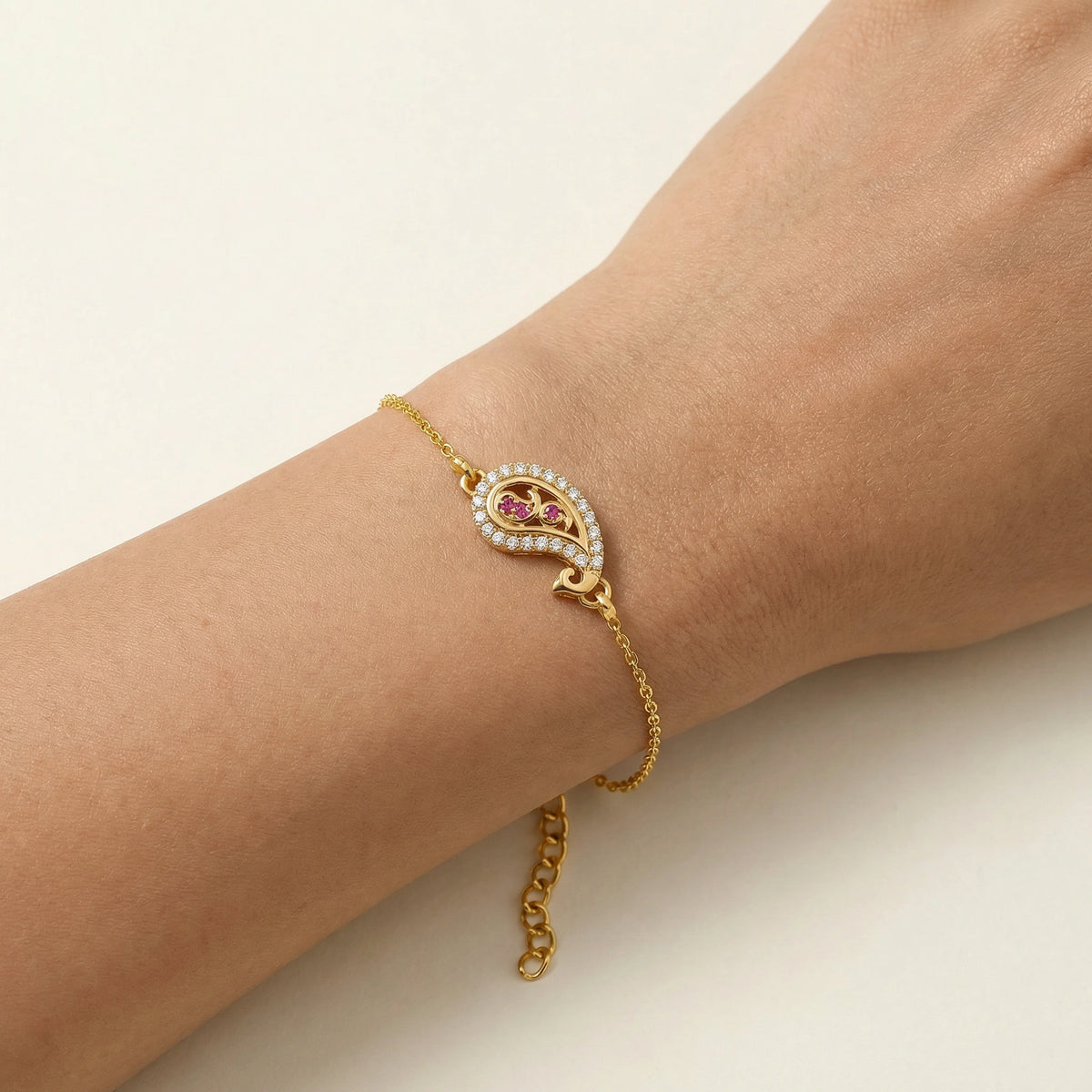 18k gold plated bracelet with a heart-shaped gemstone on a wrist against a light background