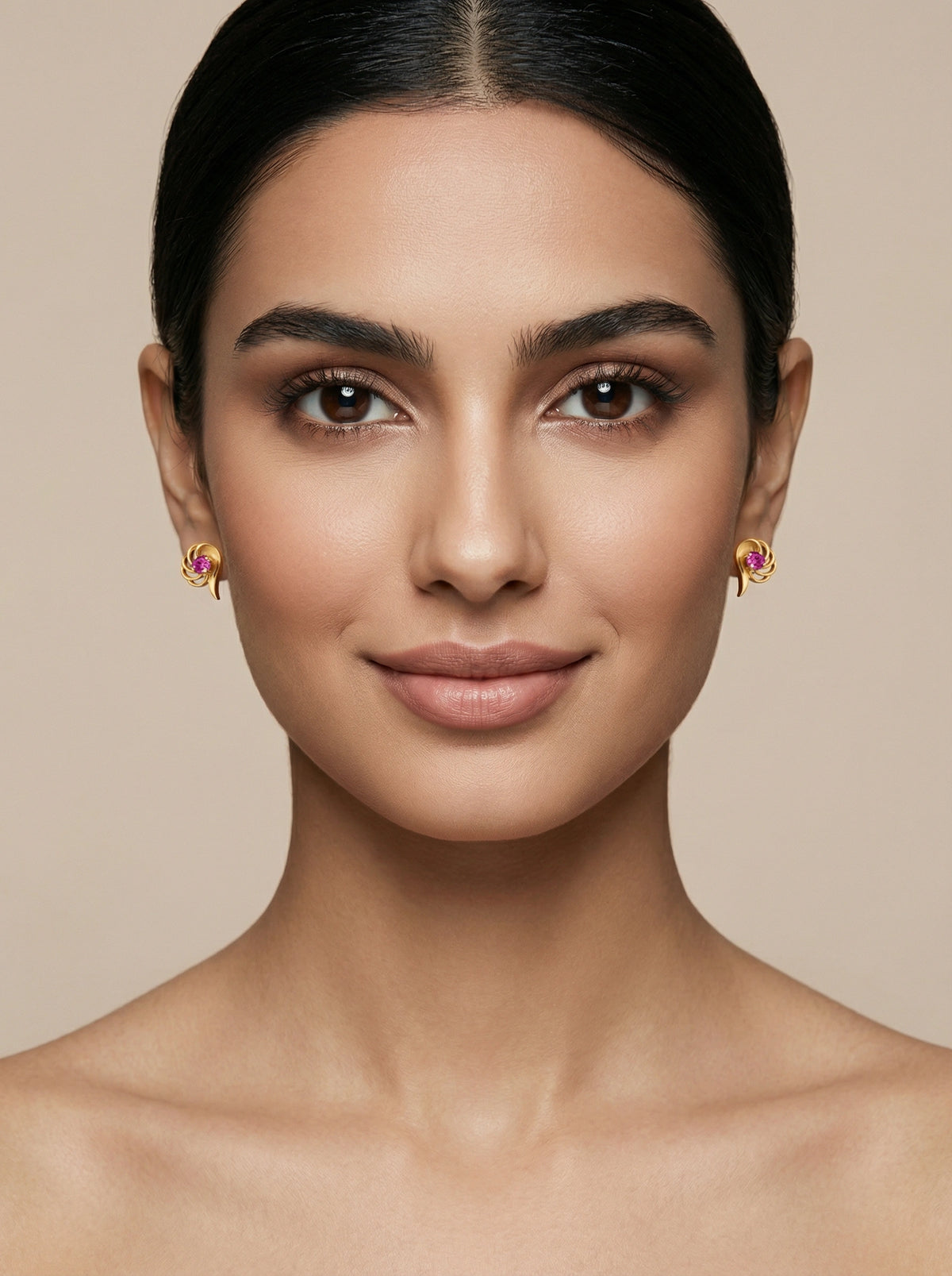 woman wearing 18k gold plated earrings with a neutral background
