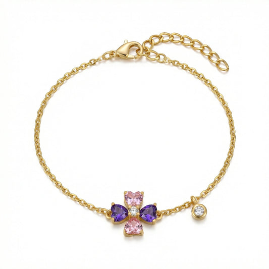 18k Gold plated bracelet with a cross charm featuring pink and purple stones on a white background