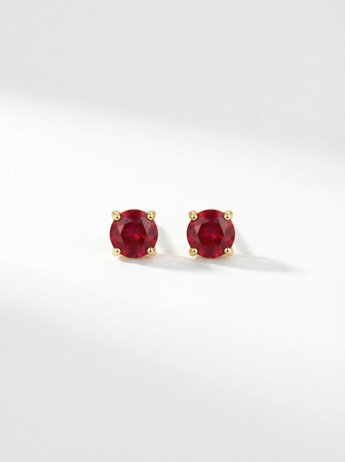 pair of18k gold plated  red gemstone stud earrings on a white background