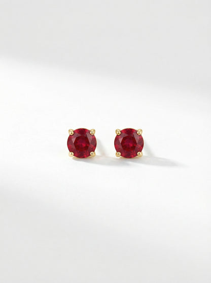 Pair of18k gold plated  red gemstone stud earrings on a white background