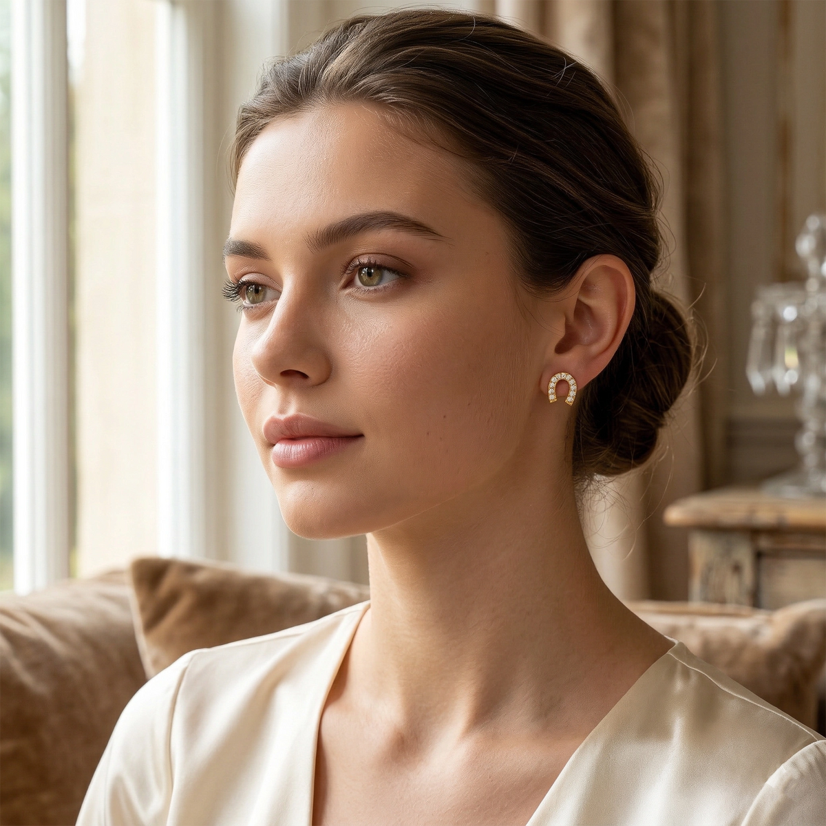 woman wearing earrings in a cozy indoor setting 18k plated