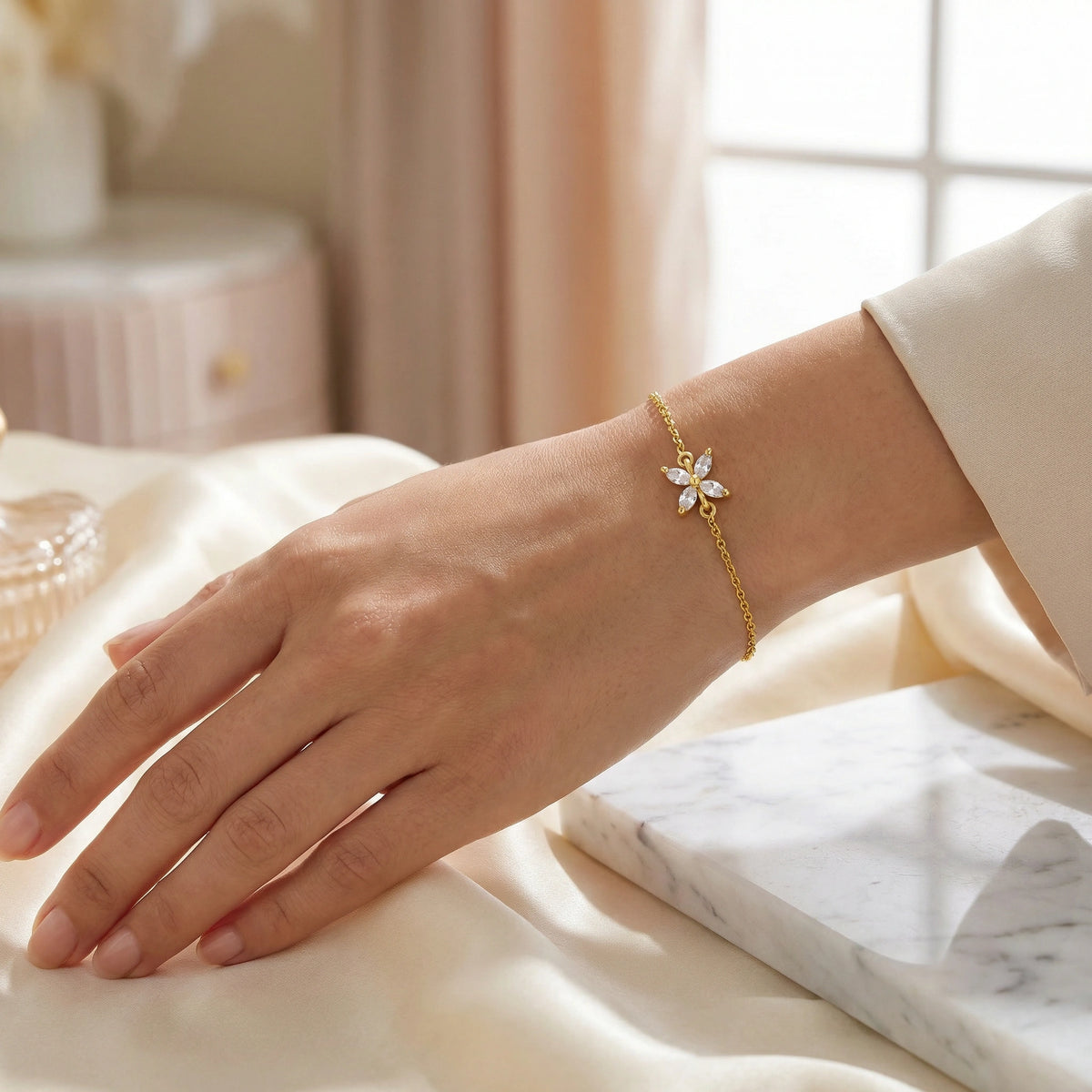 18k gold plated bracelet on a hand with a soft, blurred background