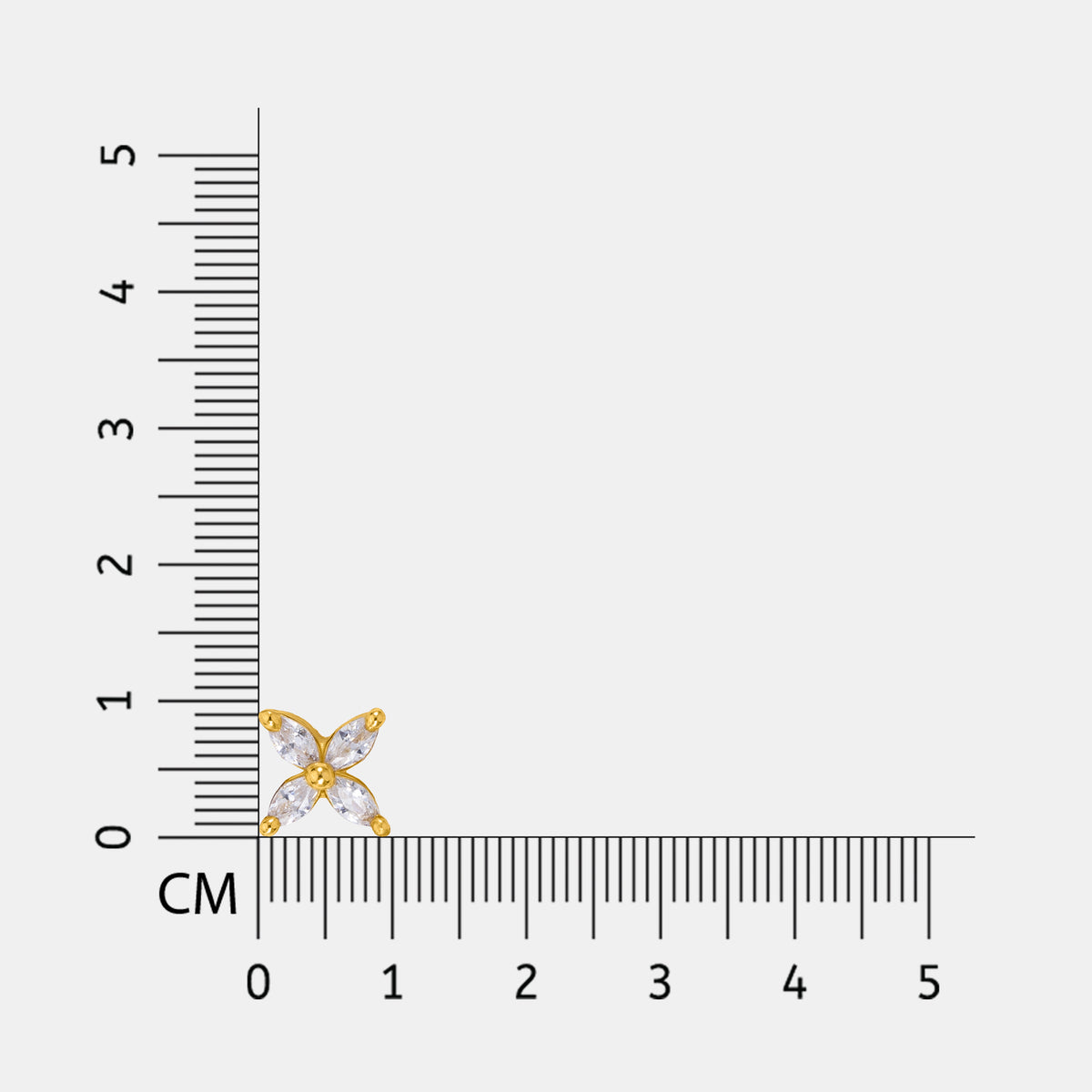 18k gold plated and silver earring next to a ruler on a white background