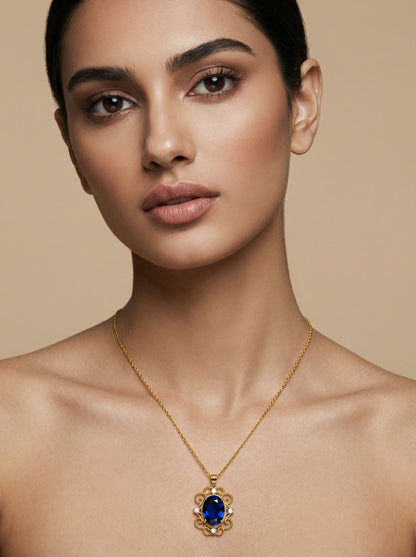 Woman wearing a 18k  gold plated  necklace with a blue gemstone pendant against a beige background