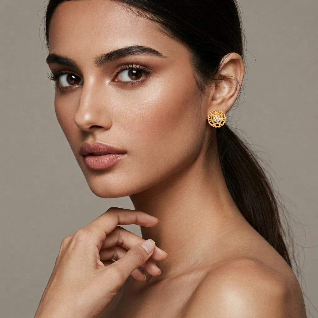 woman wearing 18k  gold plated earrings with a neutral background