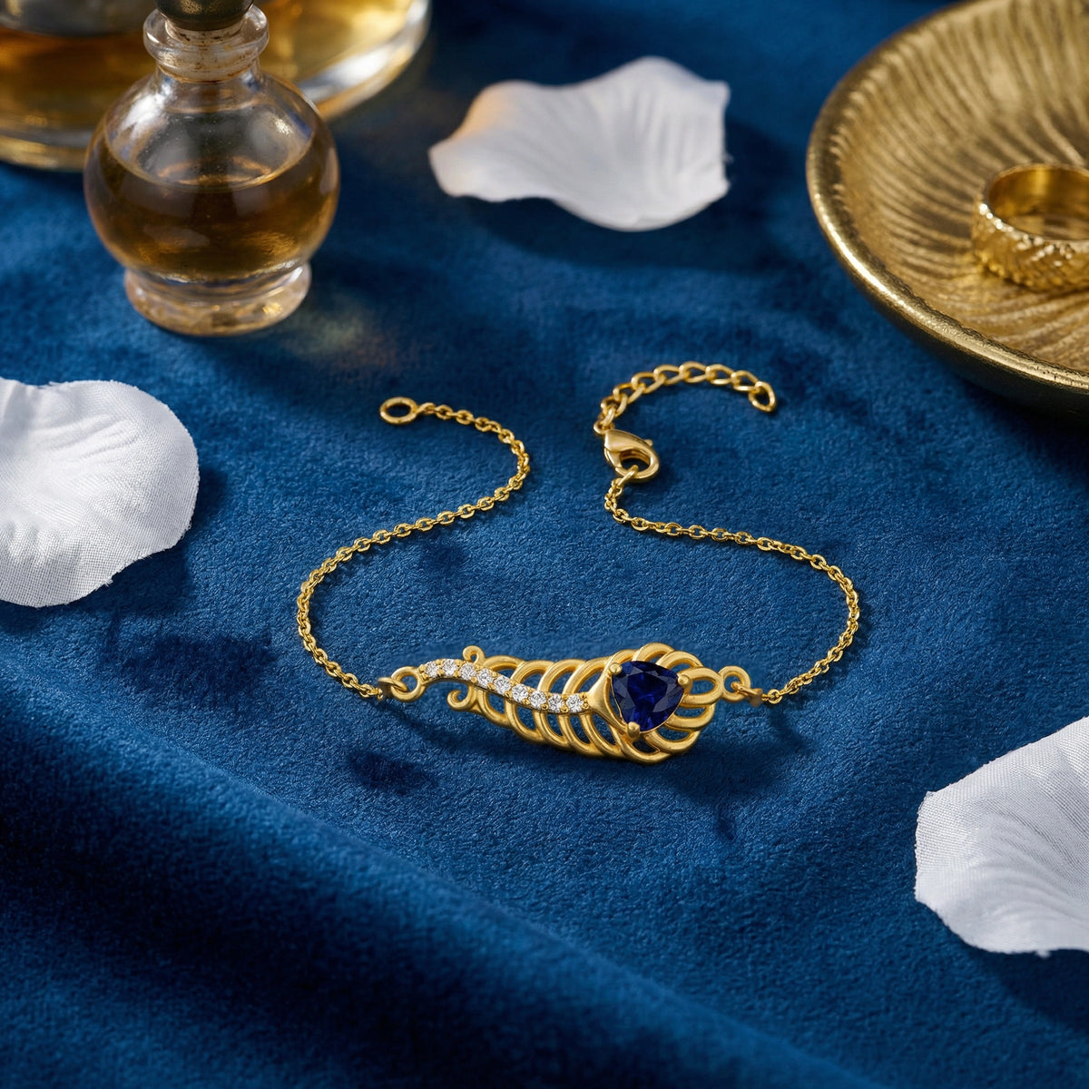 18k gold plated bracelet with a blue gemstone on a blue fabric background