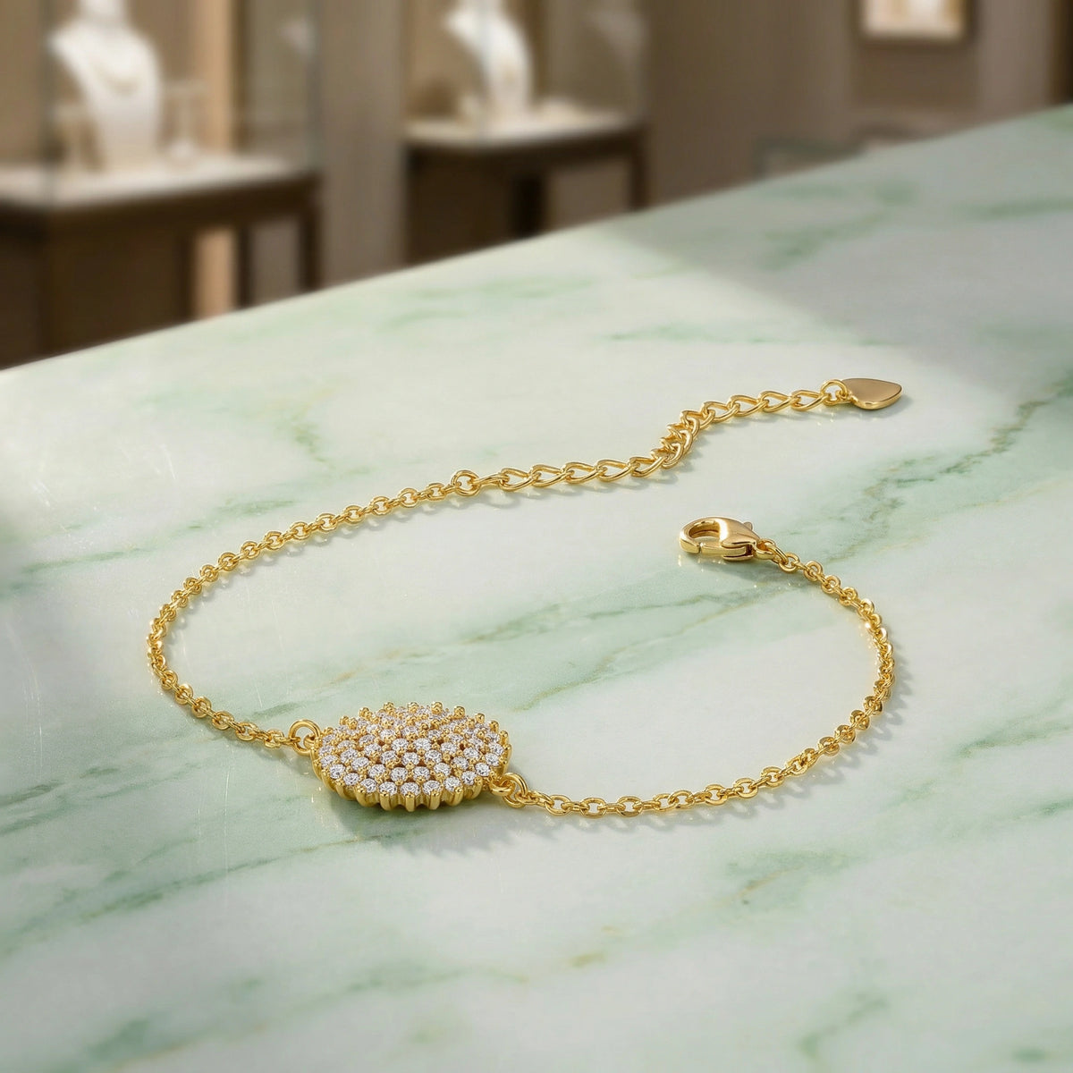 18k gold plated bracelet with a circular diamond clasp on a marble surface