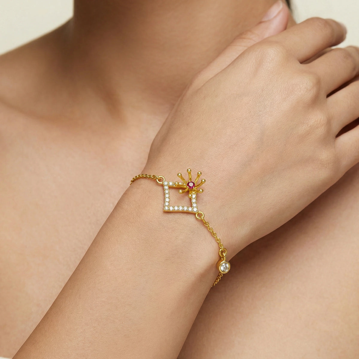 18k gold plated bracelet with a star and gemstone design on a wrist.
